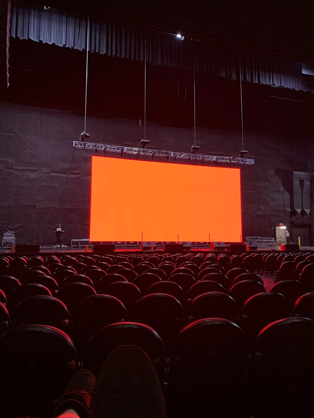 Performance lit by moving head spot fixtures