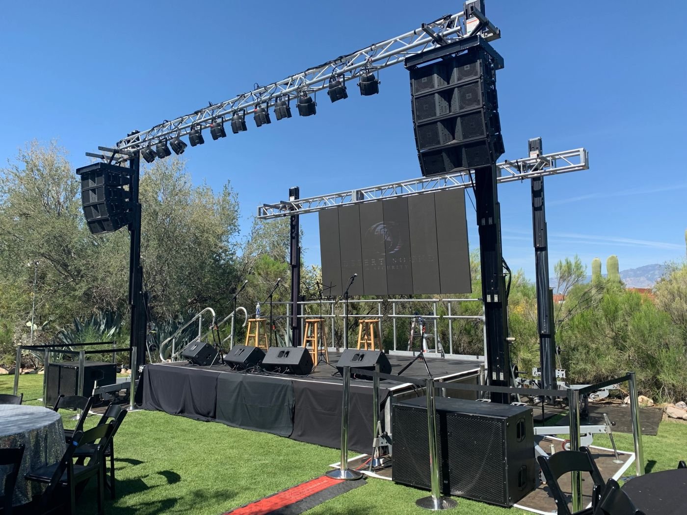 Stage lighting and line array speakers rigged for a Liven Productions event